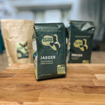 Load image into Gallery viewer, A bag of Medium Roast Guatemala from Big Year Coffee rests on a cutting board displaying the front of the packaging.
